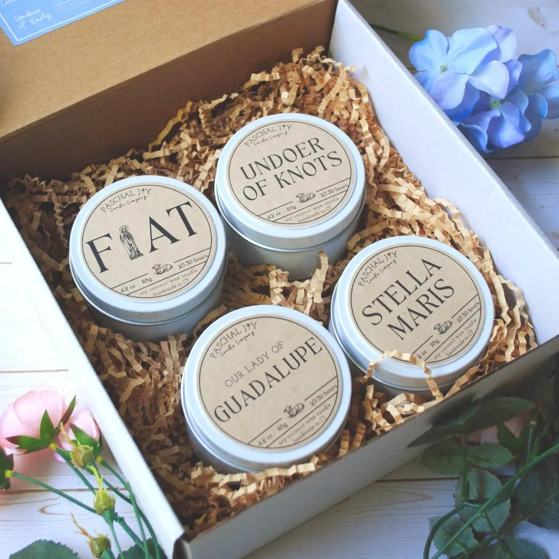4 candle tins in a box with flowers