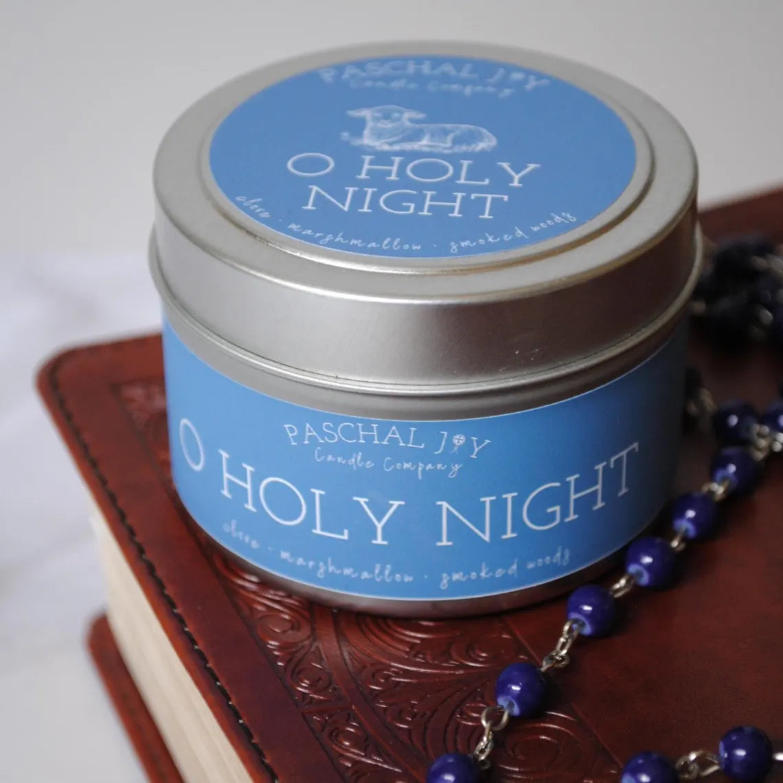 Candle tin labeled 'O Holy Night' by Paschal Joy Candle Company on a white background.