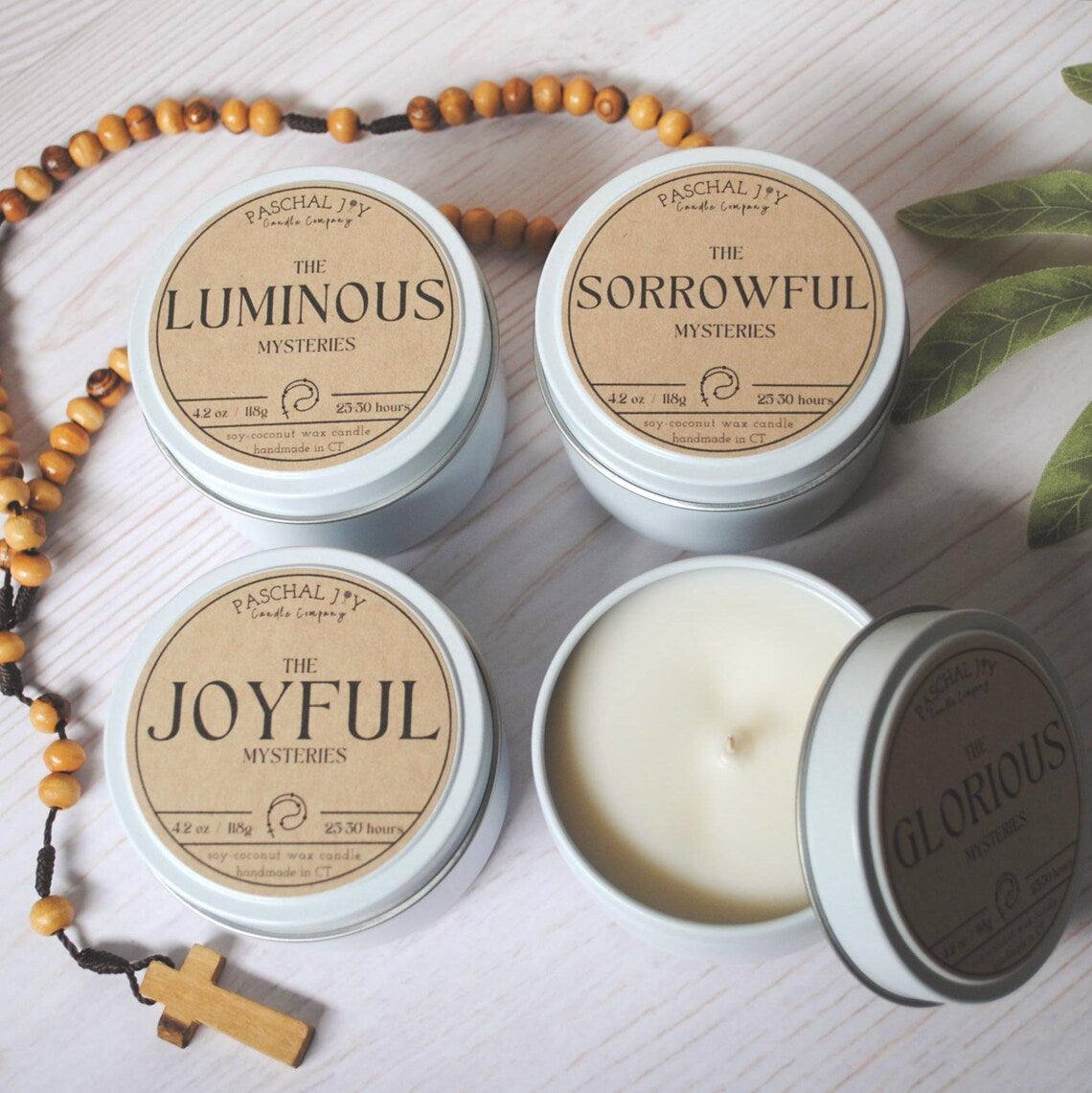 Rosary Candle Collection - white tins with a rosary on a grey background