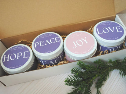 Four candles in a box with 'Hope', 'Peace', 'Joy', and 'Love' text on their lids.