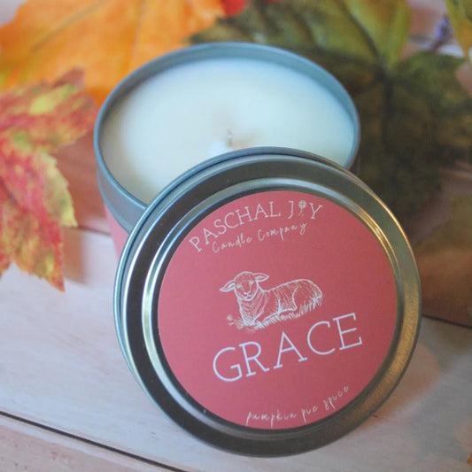 Grace Pumpkin Pie Spice Candle with fall leaves in the background