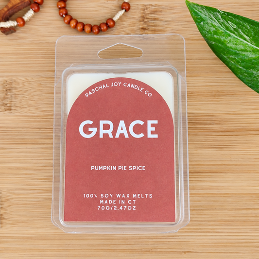 Orange wax melt container with PUMPKIN PIE SPICE written on front