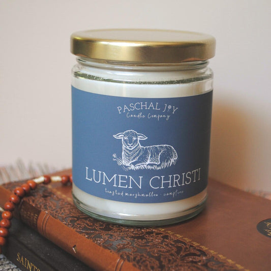 Candle jar grey label featuring a sheep illustration on a wooden surface.