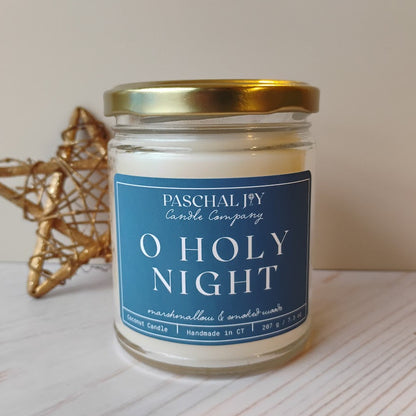 Candle jar labeled 'O Holy Night' from Paschal Joy Candle Company on a light surface.