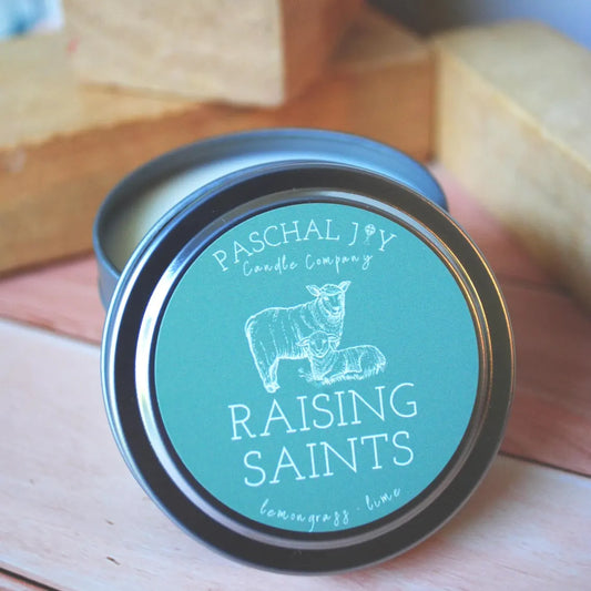 Raising Saint Catholic Candle Tin with childrens blocks in background