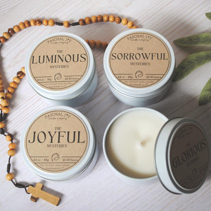 Rosary Candle Collection - white tins with a rosary on a grey background