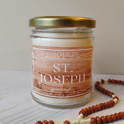 Candle jar labeled 'St. Joseph' with a gold lid on a light surface.