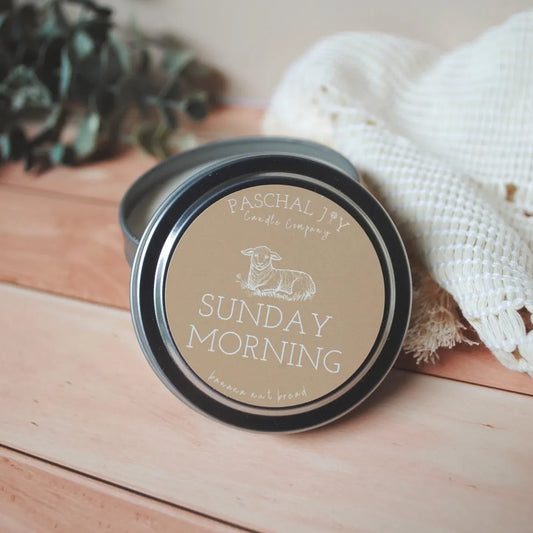 Sunday morning candle tin with wood background and cream cloth