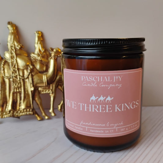 Amber Candle with We Three Kings Label and Gold statue in background
